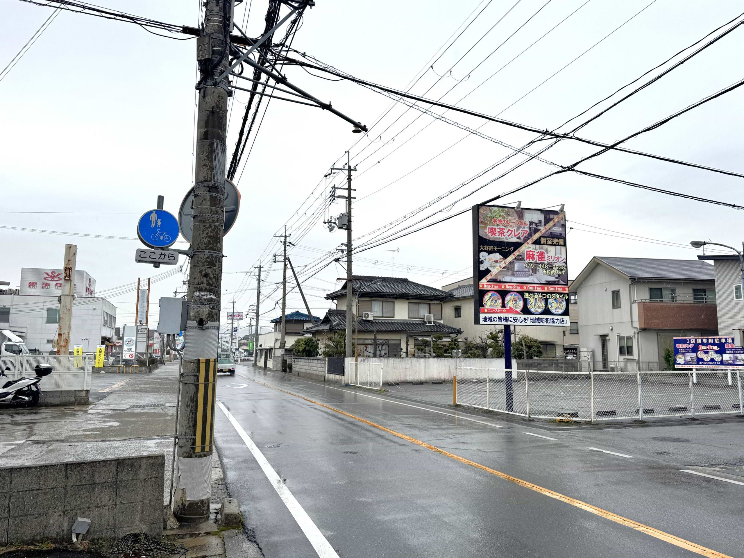 写真の屋外広告看板から20ｍ先にある大型コインランドリー店の隣に当店がございます