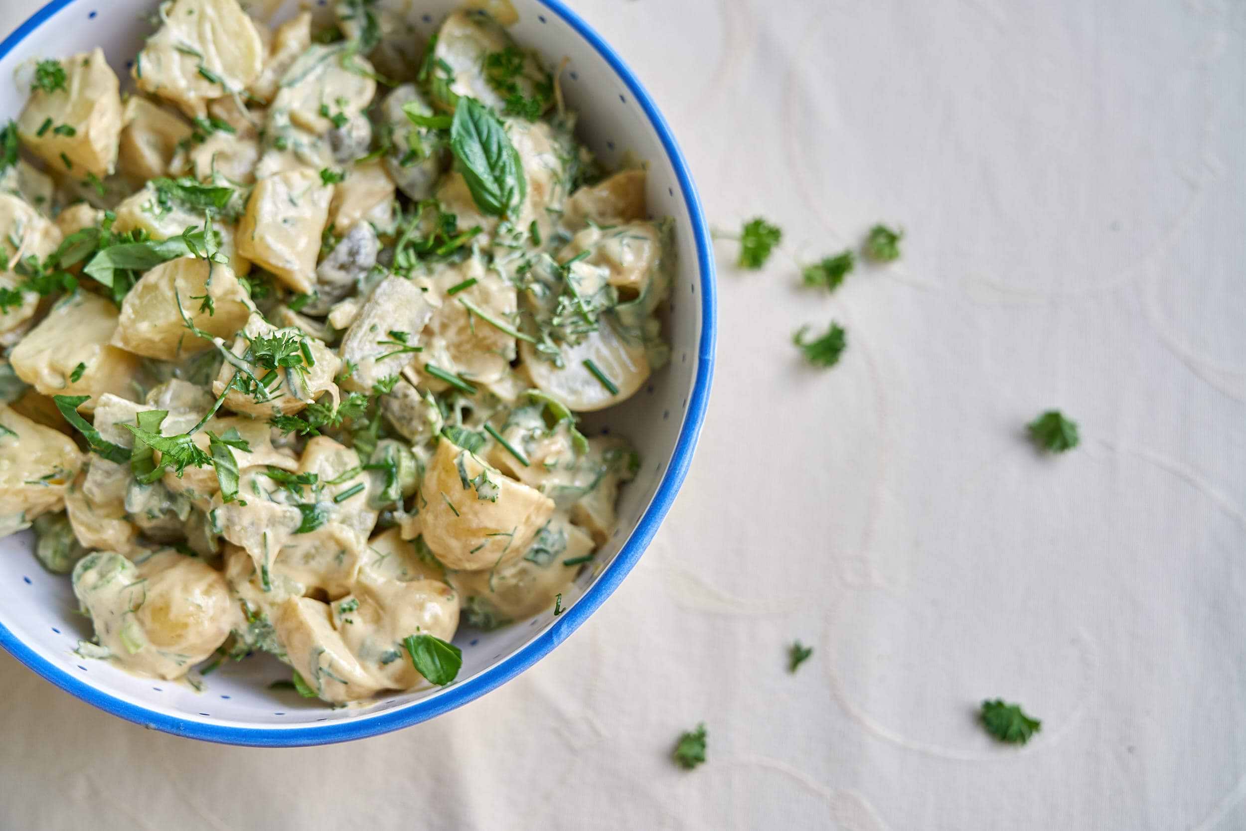 creamy potato salad with fresh herbs in a bowl