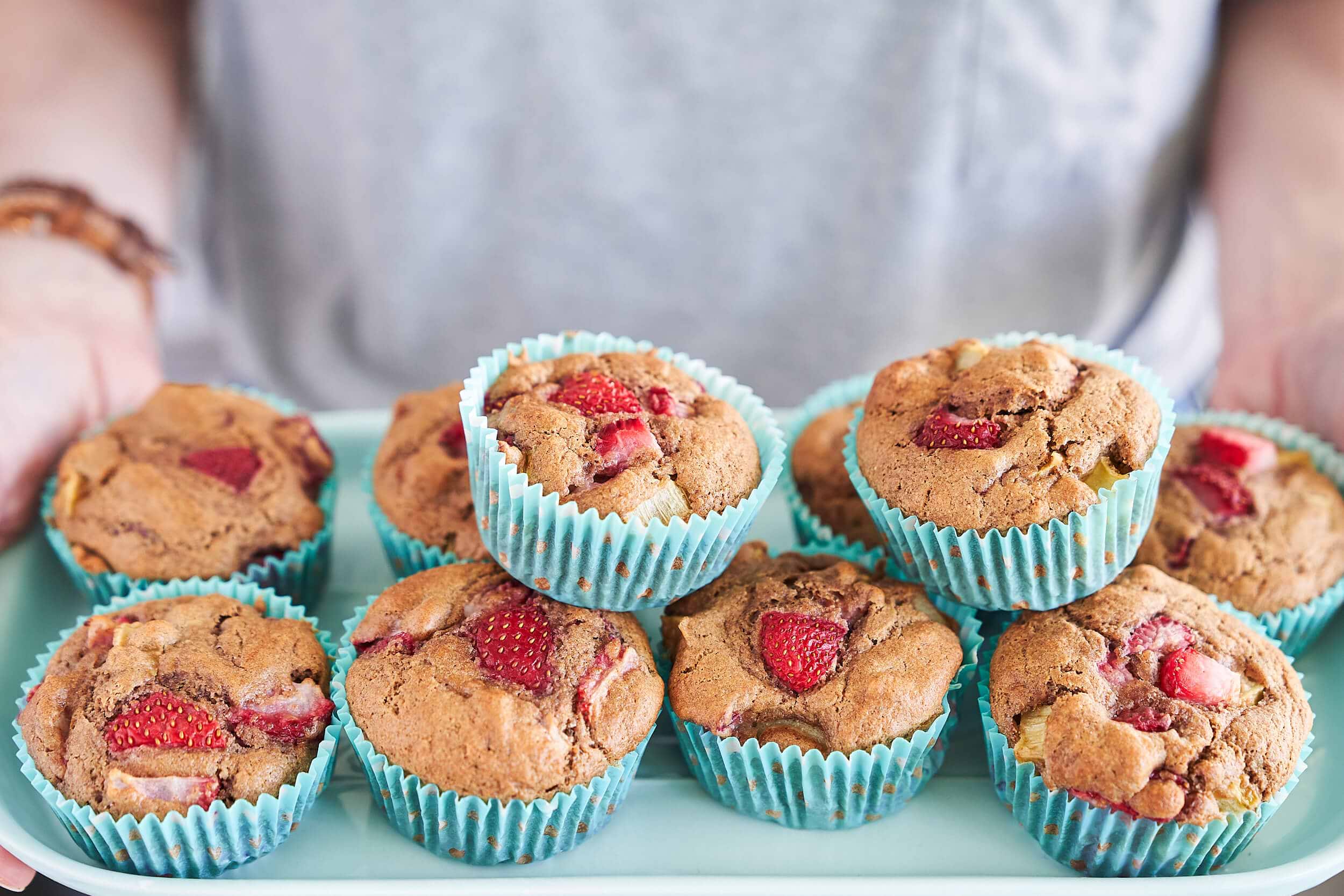 Holding plate of Strawberry Rhubarb Muffins.