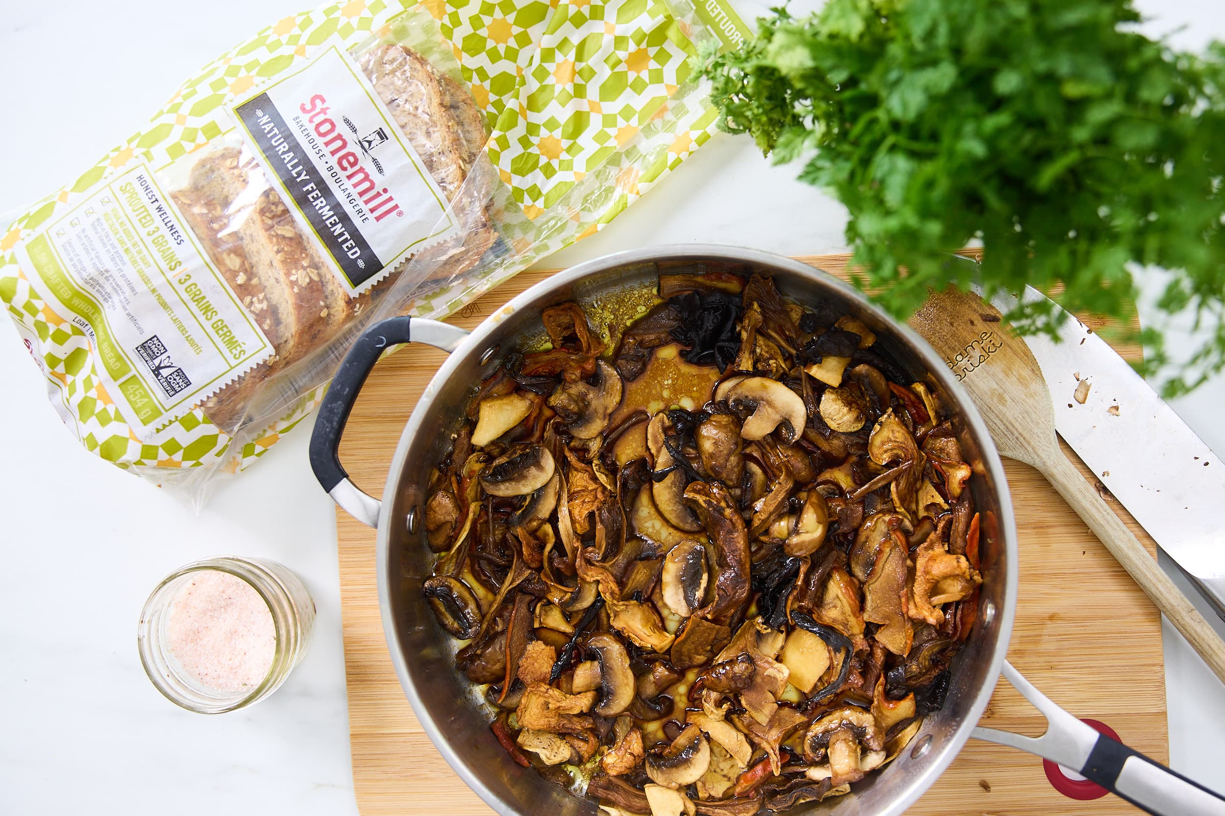 Mushrooms on a pan with a loaf of bread