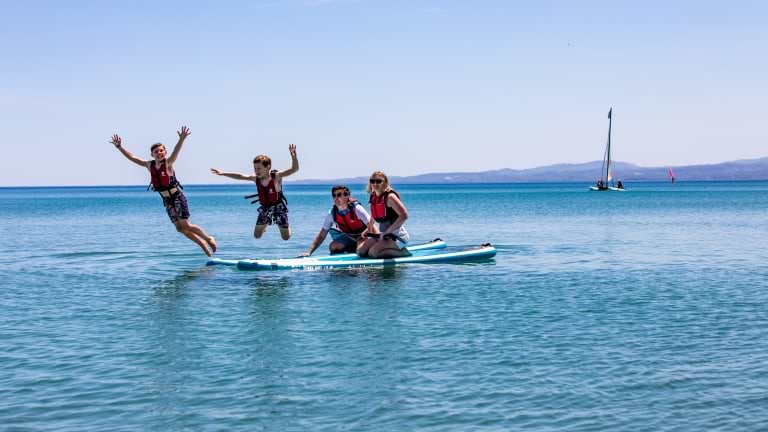 Paddle boarding fun at Messini Beach Club