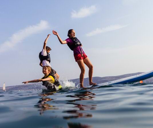children playing on a paddle board