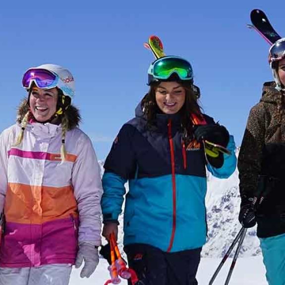 group of skiers walking and carrying their skis