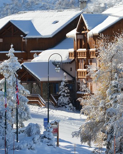 View of a snow covered Neilson Mountain Collection hotel