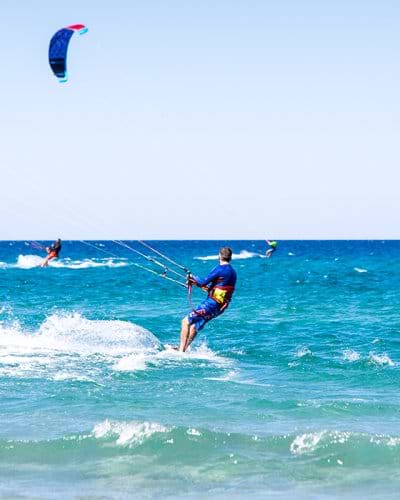 People kitesurfing on holiday in Sardinia
