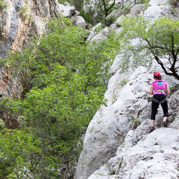 Girl rock climbing in the Paklenica National Park in Croatia
