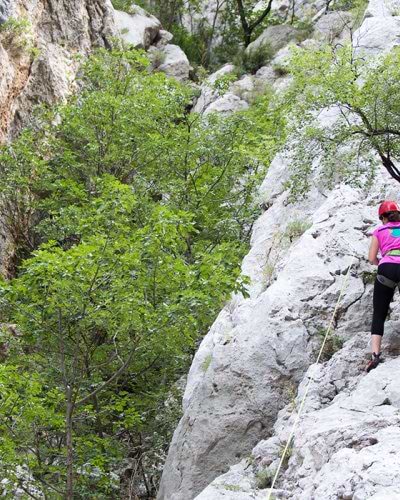 Girl rock climbing in the Paklenica National Park in Croatia