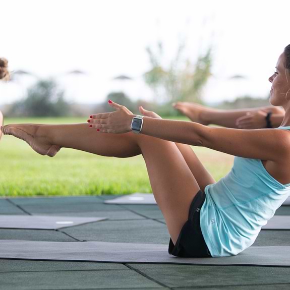 Group of people doing yoga outdoors