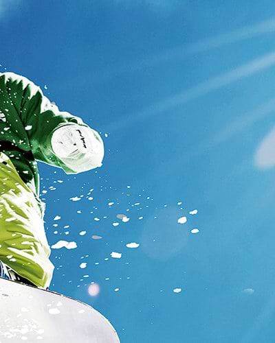 snowboarder jumping in powder snow