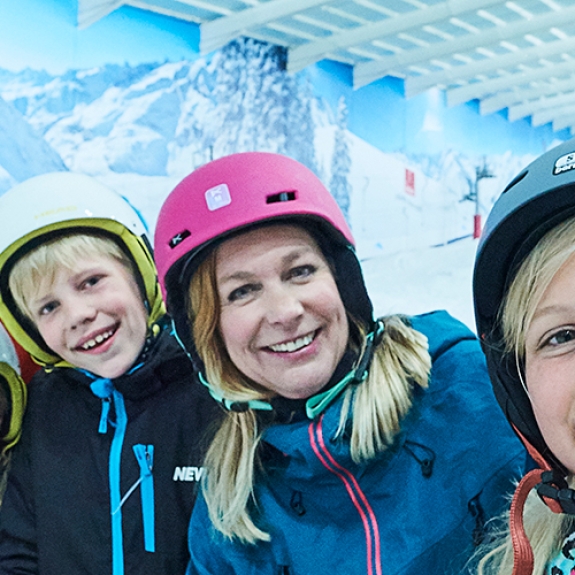 family skiing in the snow centre