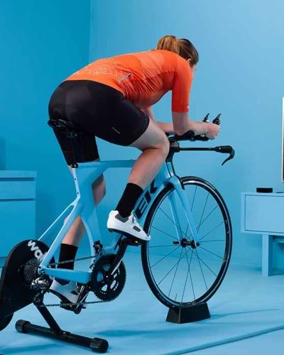 Man in living room and a static bike joining a Zwift ride