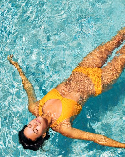 woman floating in pool