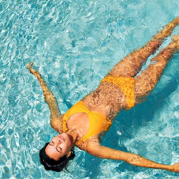 woman floating in pool