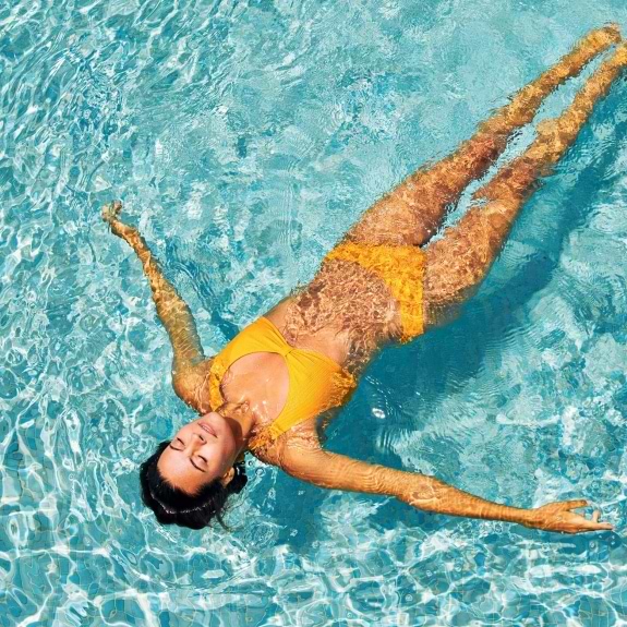 woman floating in pool