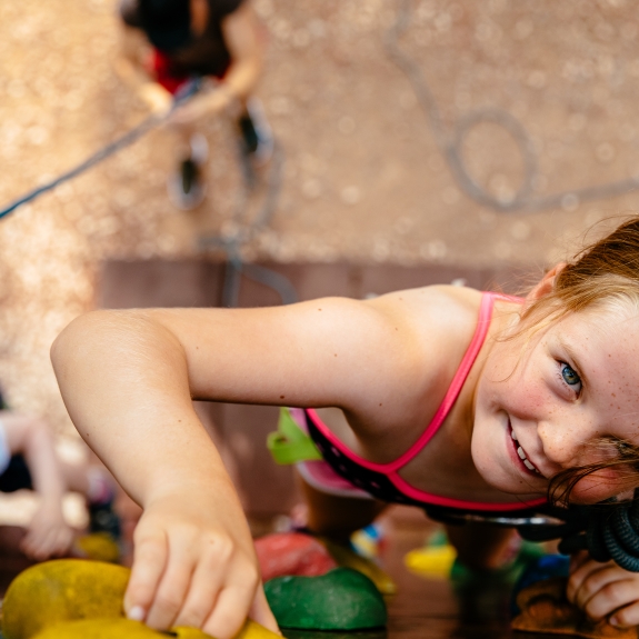 Girl climbing the wall