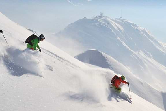 Skiers and Snowboard on a powder run