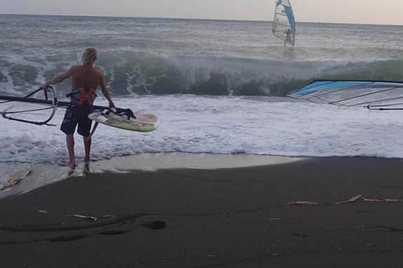 two people about to go windsurfing