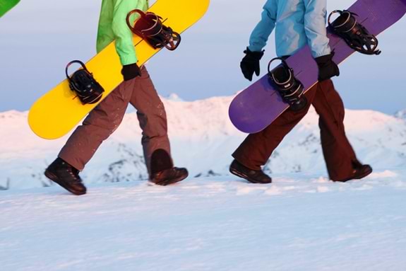 snowboarders walking with their boards