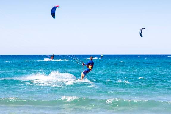 People kitesurfing on holiday in Sardinia