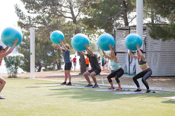 Group of people doing fitness with balance balls
