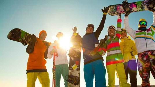 group of young skiers and snowboarders