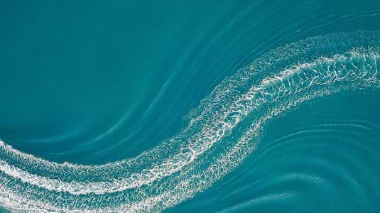 Aerial image of wakeboarder and speed boat