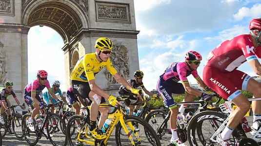 Yellow jersey tour de France cyclist in Peleton at the Arc d'Triumph