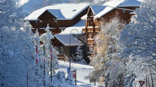 View of a snow covered Neilson Mountain Collection hotel