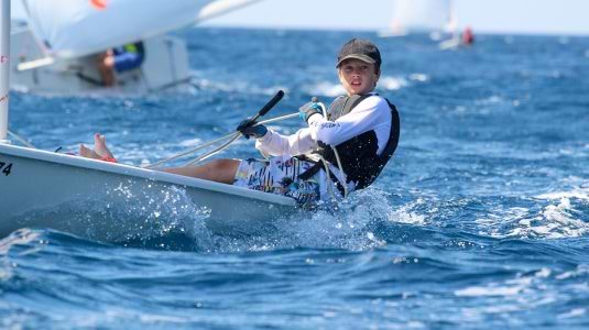 young boy dinghy sailing