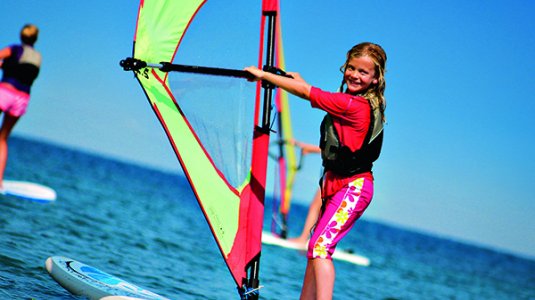 A girl on a windsurfing board