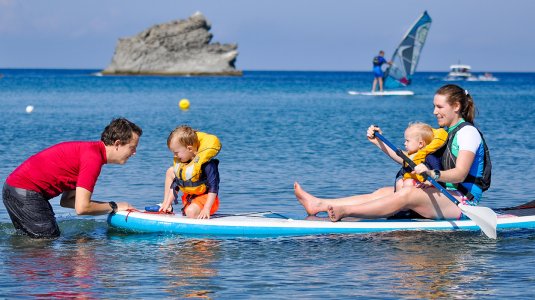 Family on stand up paddle board