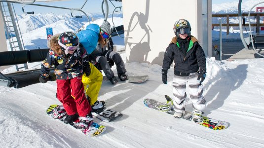 snowboarders getting off a lift