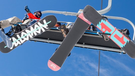 snowboarders on a chairlift