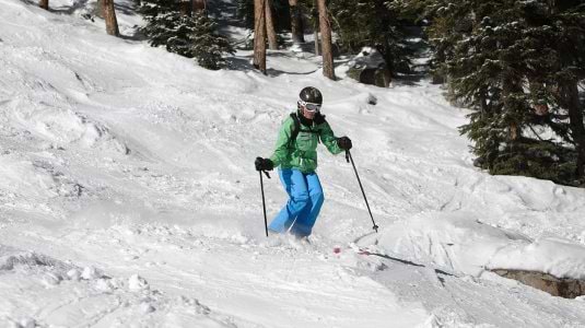person skiing moguls
