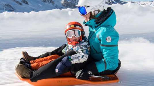 A mother and child on a luge