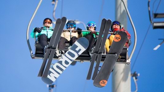skiers and snowboarders on a chairlift