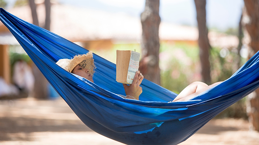 Reading a book in a hammock