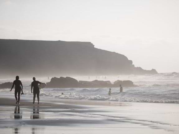 a couple surfing at La Pared