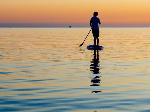 Sardinia paddle boarding at sunset