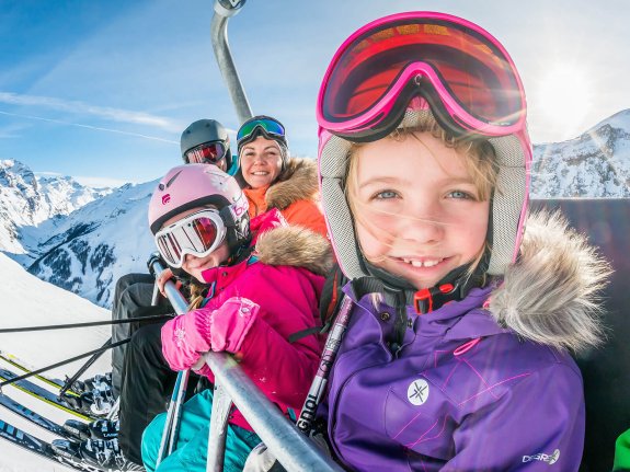 Young family on a ski lift