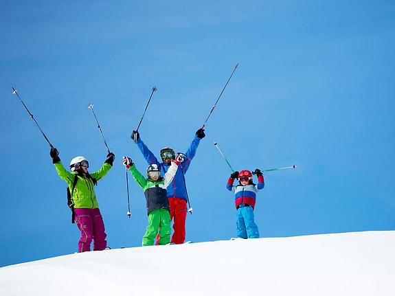 Family at the top of a ski slope