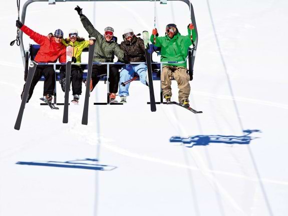 Friends on a ski lift in Andorra