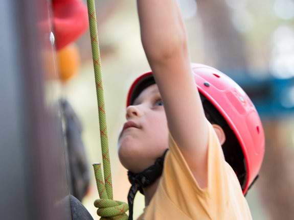 young boy on a climbing wall