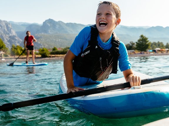 young boy on paddle board