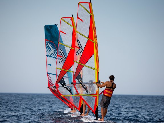 group of people windsurfing