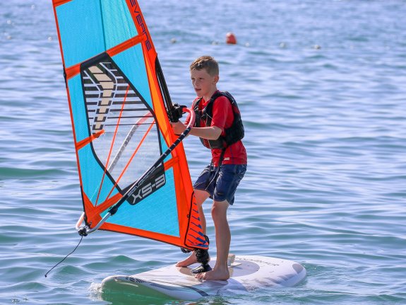 boy windsurfing