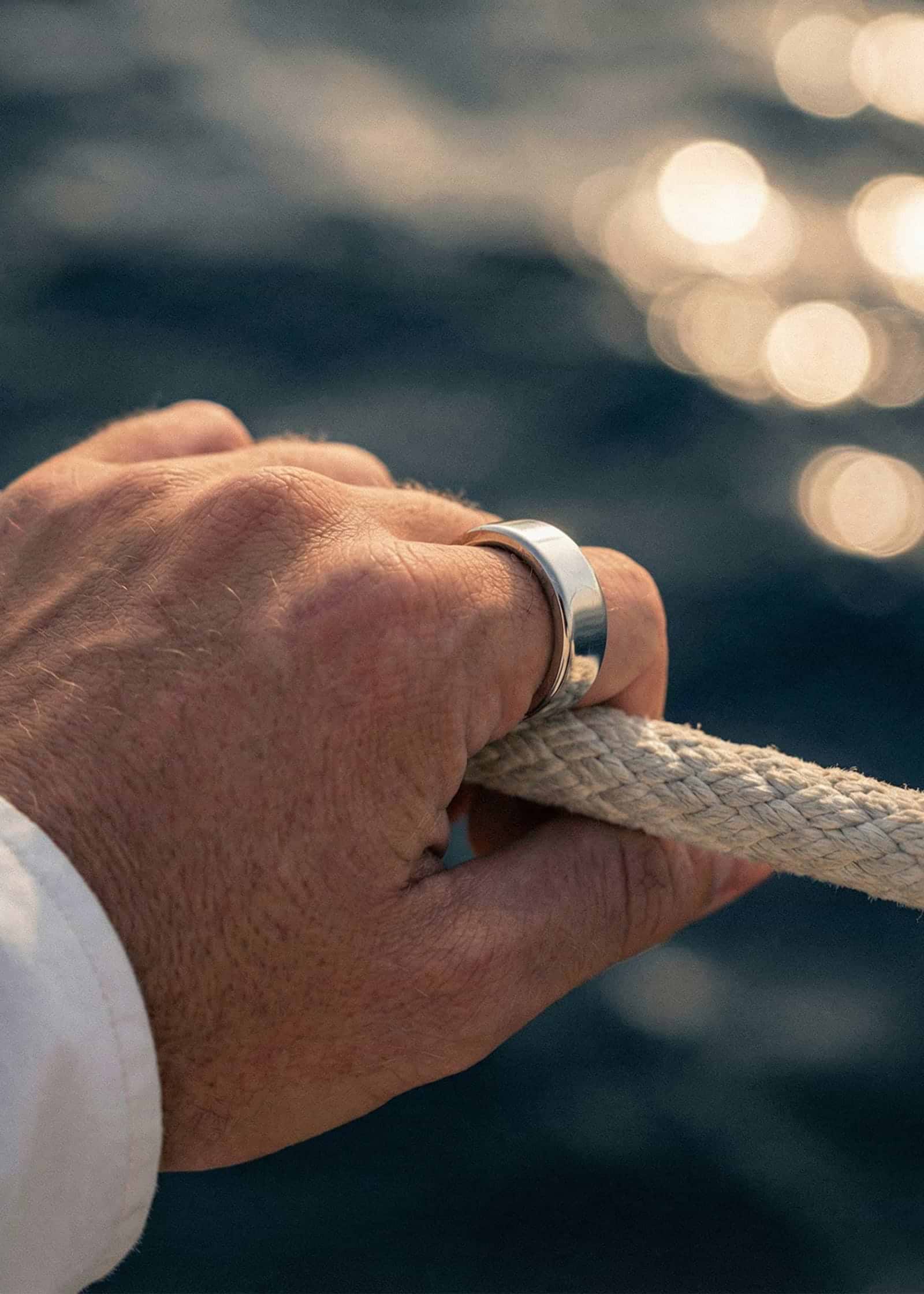 Ultrahuman Ring PRO on a hand pulling a rope
