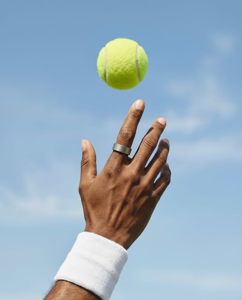 Ultrahuman Ring AIR on a hand reaching for a tennis ball