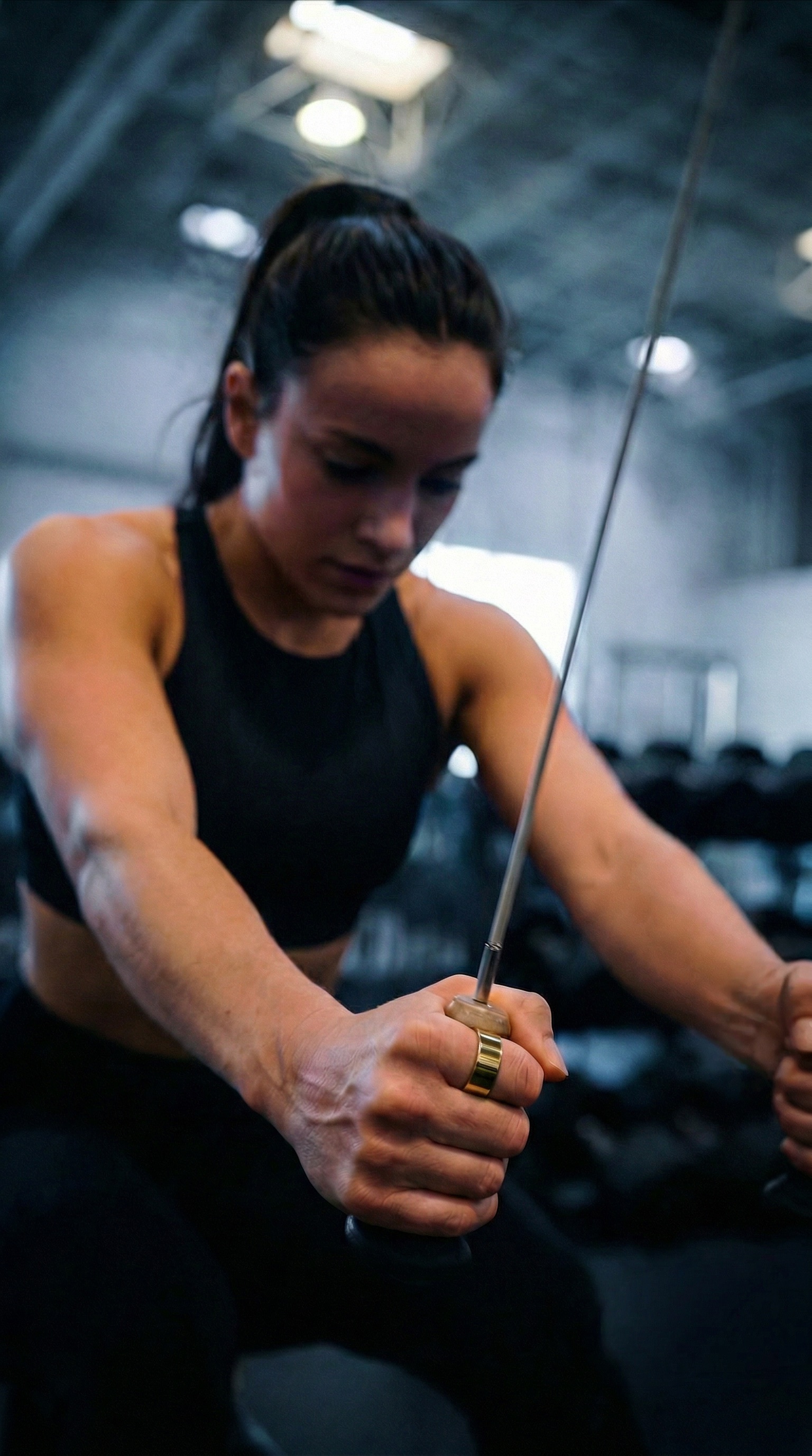 Ultrahuman Ring AIR in gold, on a hand during a gym workout