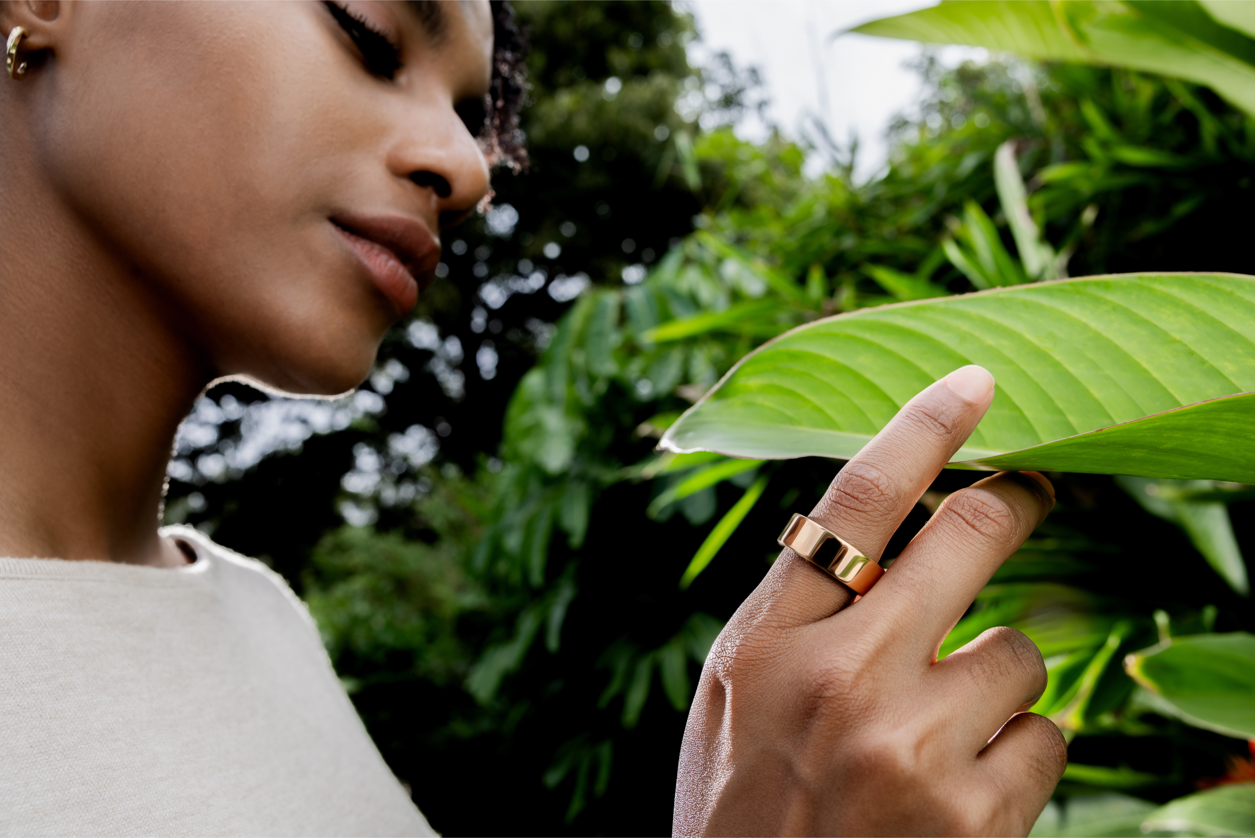 woman touching leaf wearing ultrahuman ring
